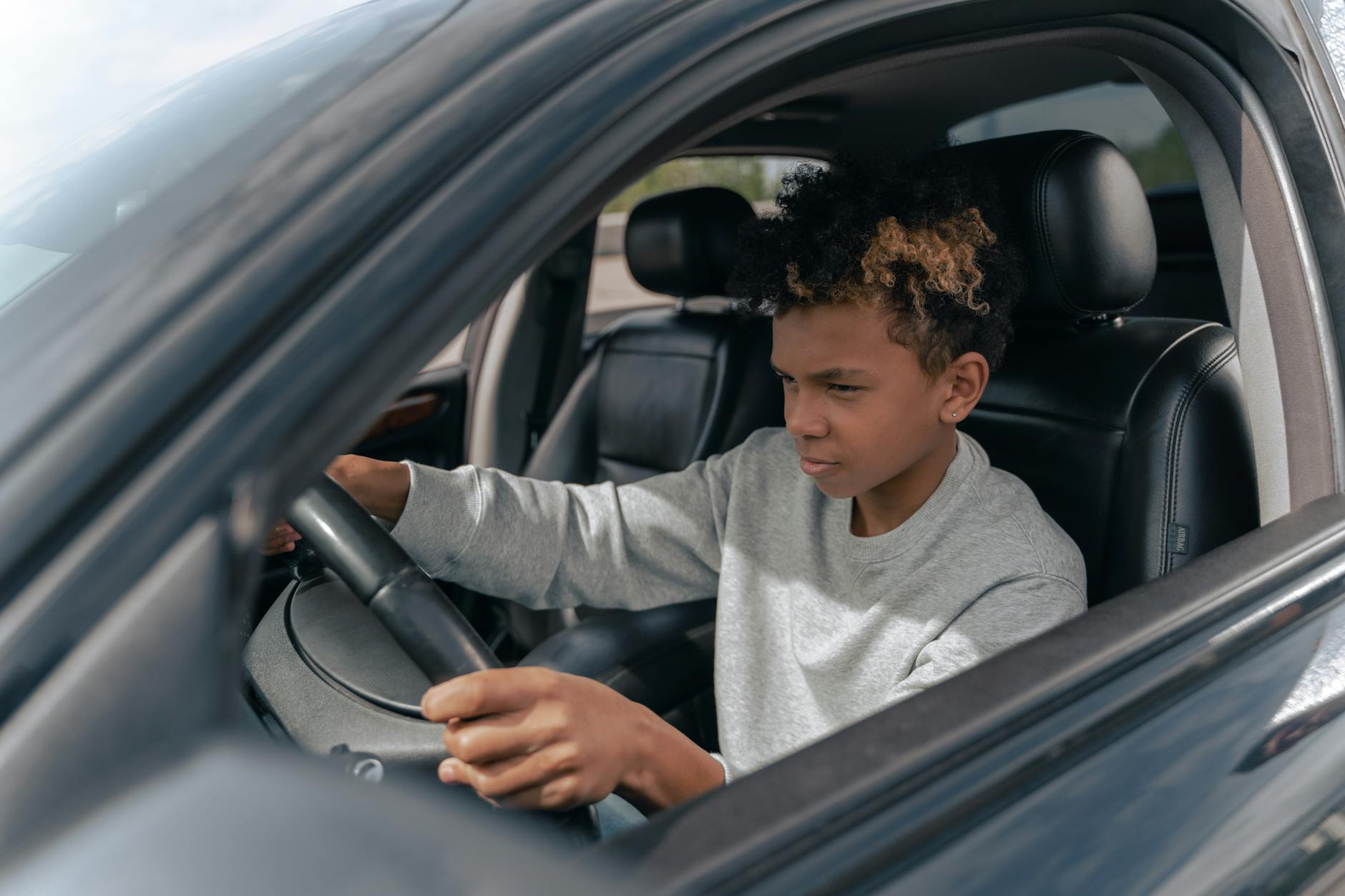 Young learner driver concentrating while practising for Irish driving test